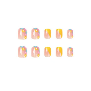 Bright yellow French press-on nails with dainty floral accents.