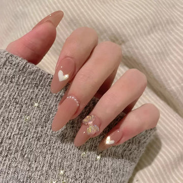 Glittery nude nails with subtle shimmer decor