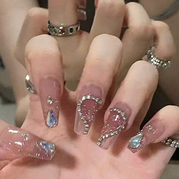 Glittery nude nails with diamond accents