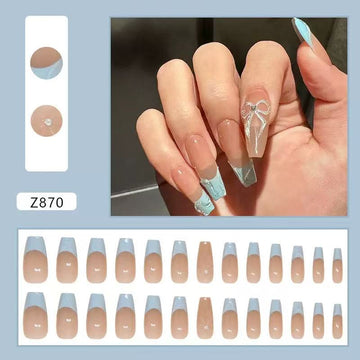 Nude stiletto nails with blue accents and glitter