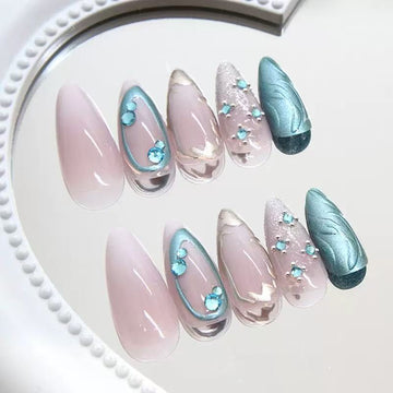Pink-and-blue glitter stiletto nails with patterns