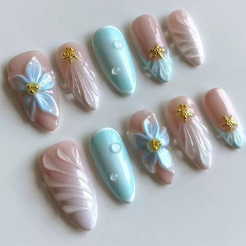 Pastel-colored nails with floral and glitter details