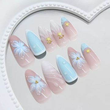 Pastel-colored nails with floral and glitter details