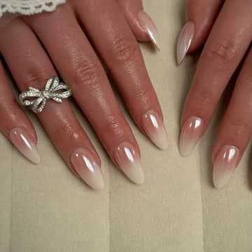 Nude nails with diamond bow decor