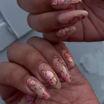 Pink nails with gold glitter floral decor