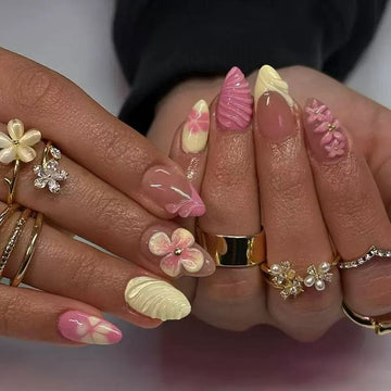 Pink-and-yellow nails with floral and glitter decor