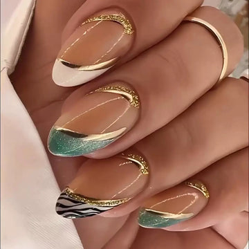 Nude nails with green-and-gold decor accents