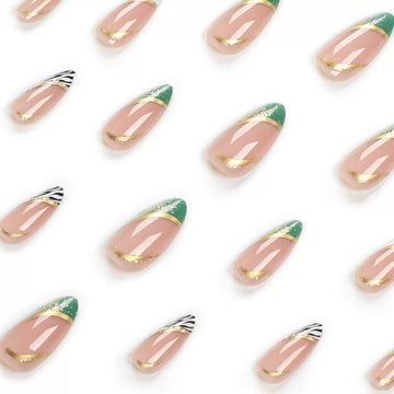 Nude nails with green-and-gold decor accents